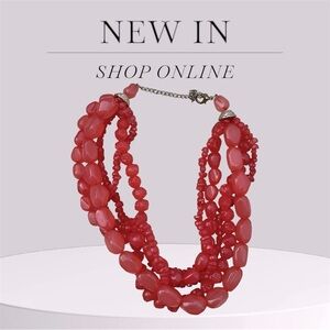 Coral color large layered beaded necklace.